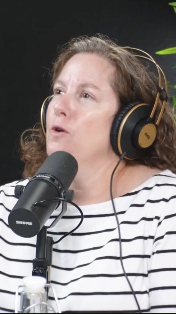 at the microphone, wearing headphones is Cora Cole, coordinator of Women’s Centres Connect, the provincial association representing nine women’s centres across Nova Scotia
